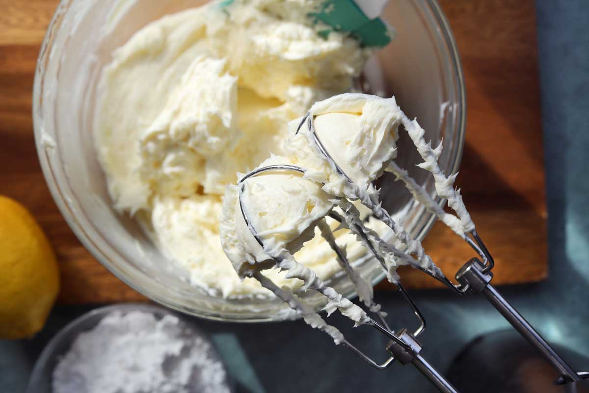 cream cheese frosting on mixer attachment after gradually adding cream cheese