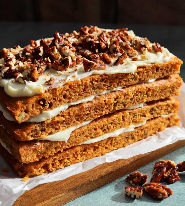 praline crunch carrot cake layer cake on a cutting board