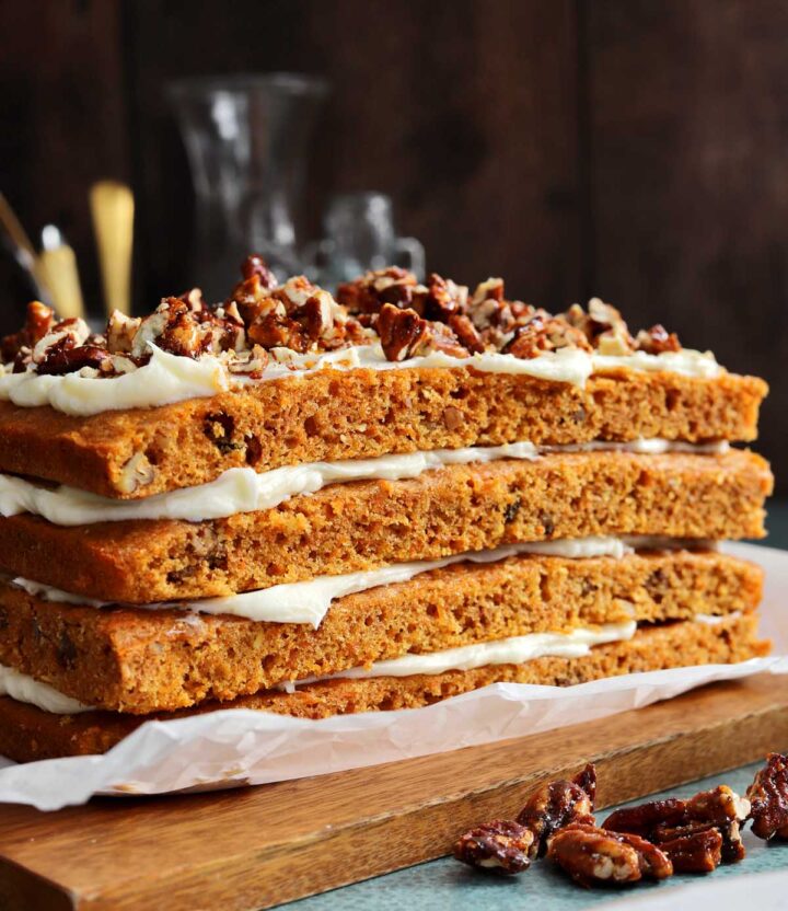 praline crunch carrot cake layer cake on a cutting board