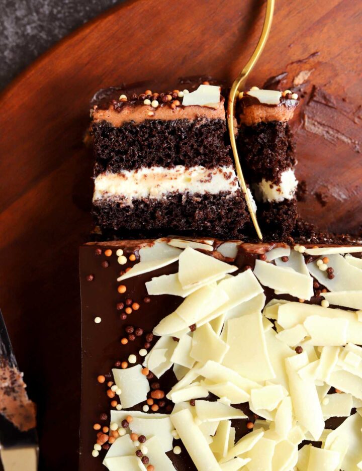 top view of tuxedo cake with slice with fork on cutting board