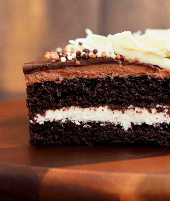 straight on view of sliced tuxedo cake showing cross section with cake and filling layers