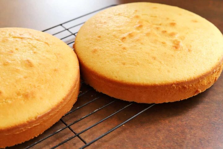 classic vanilla birthday cake layers cooling on wire rack
