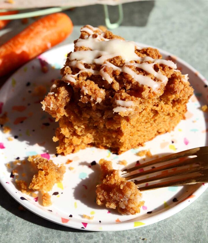 carrot cake coffee cake slice on a plate with bite and fork