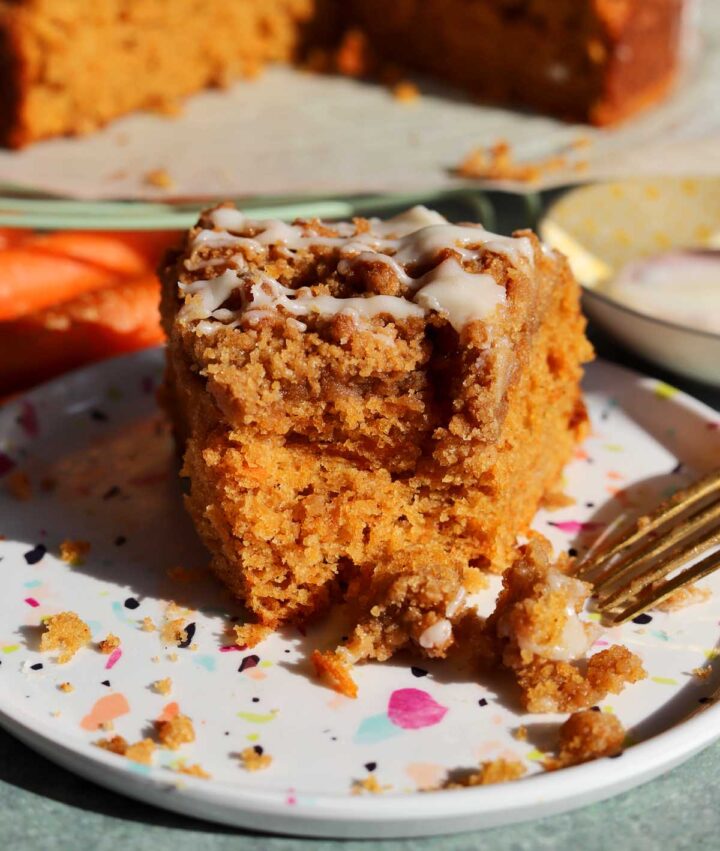 carrot cake coffee cake slice on a plate with bite and fork