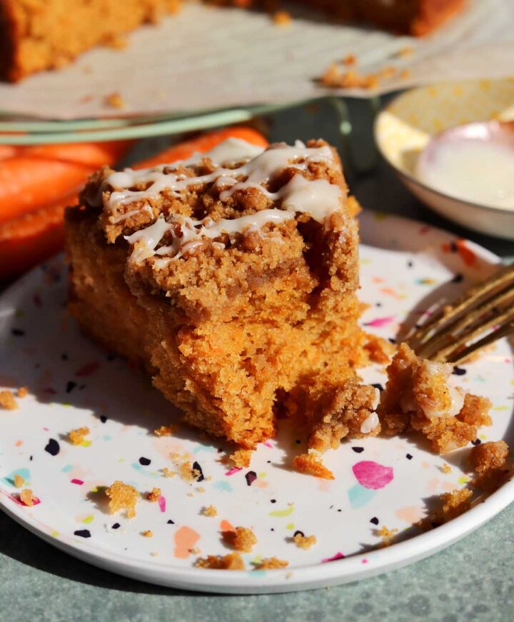 carrot cake coffee cake slice on a plate with bite and fork