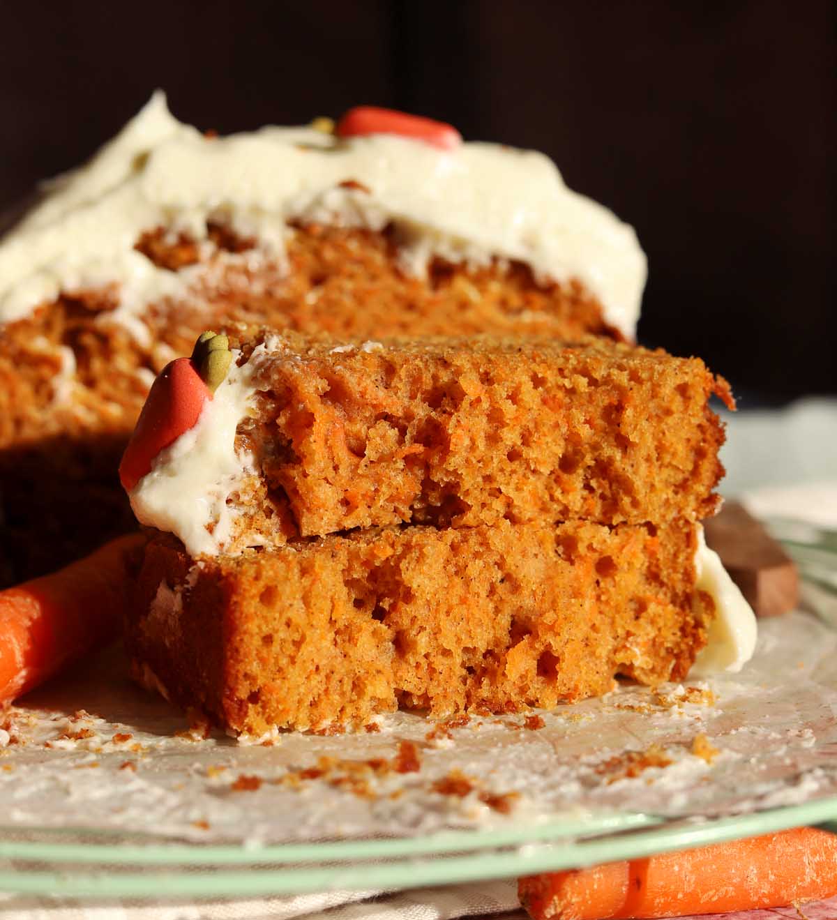 carrot cake loaf cake slice in half showing soft crumb on cooling rack