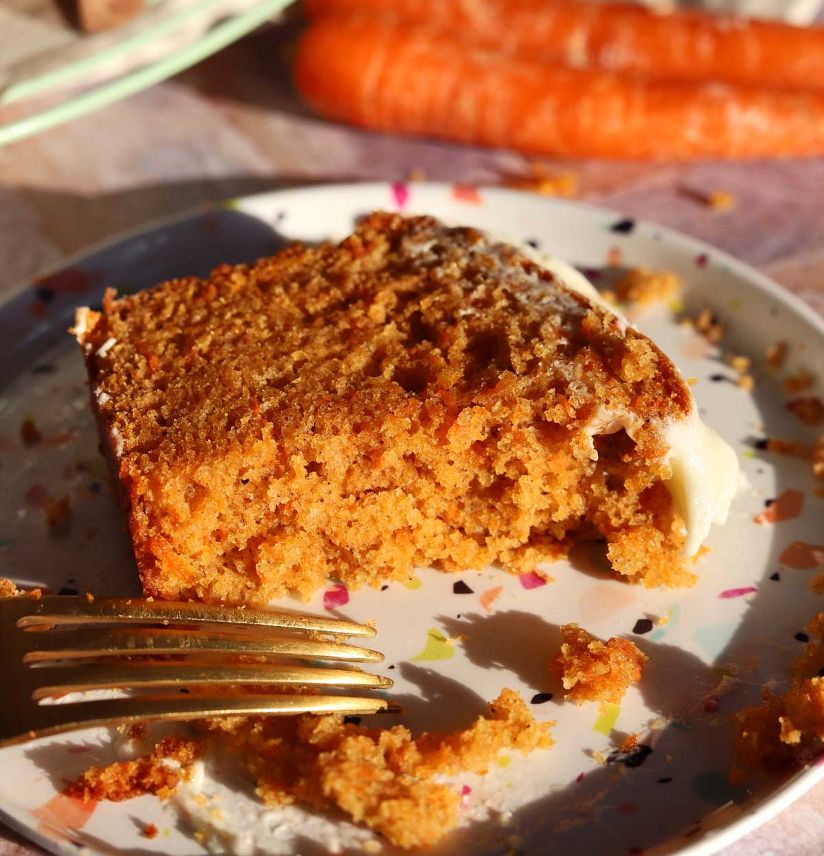 carrot cake loaf cake slice on a plate with bite and fork