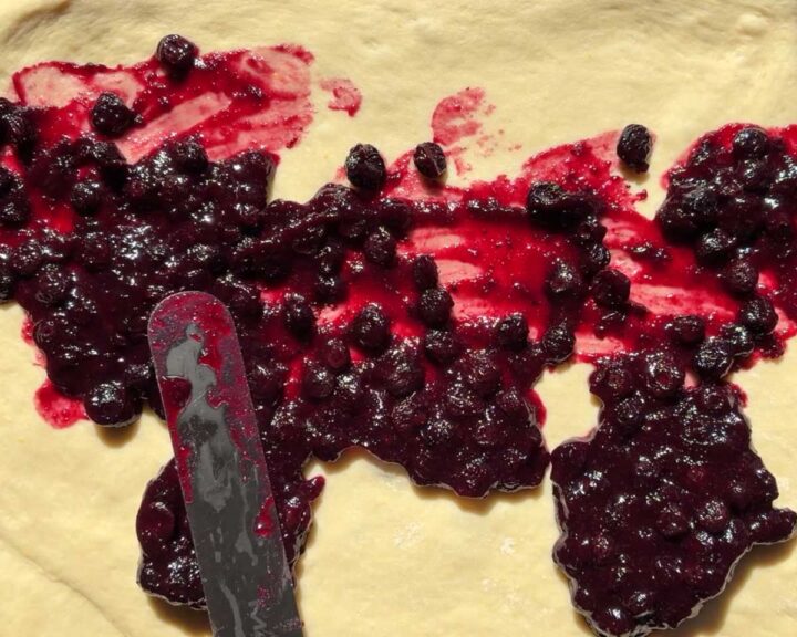spread blueberry filling over dough