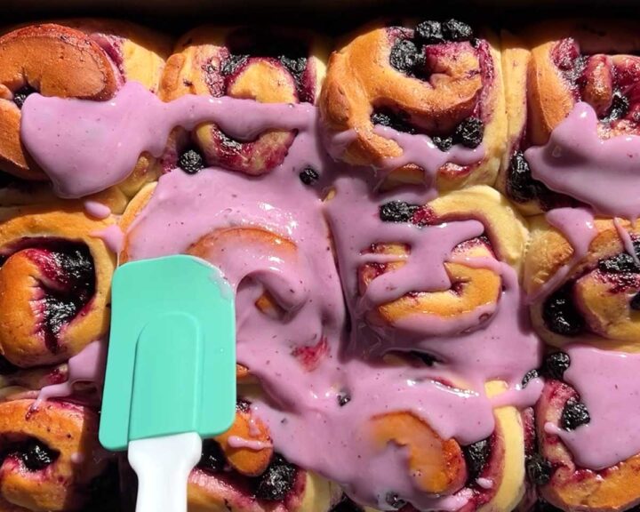 Spread icing over rolls.