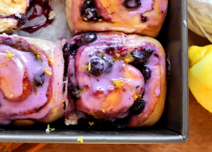 close up of lemon blueberry sweet rolls in baking pan