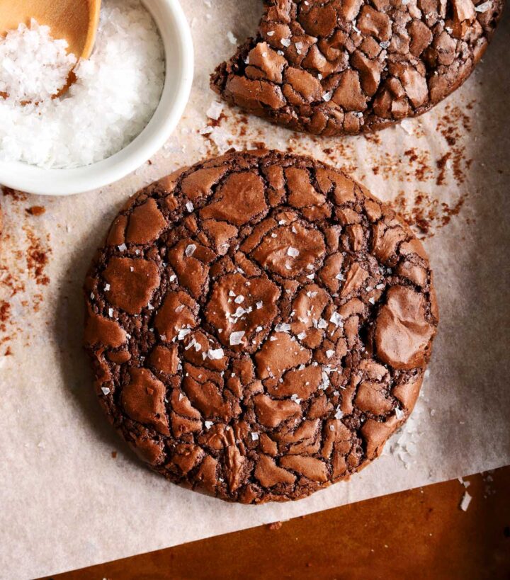 close up of chewy crinkle top brownie cookies on baking sheet