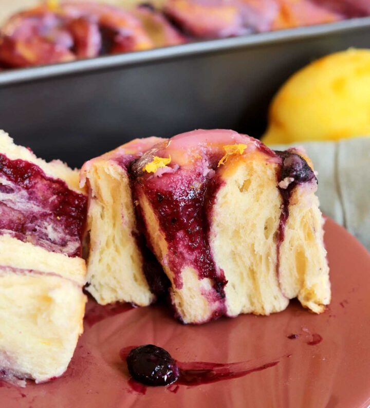 lemon blueberry sweet roll split in half on a plate