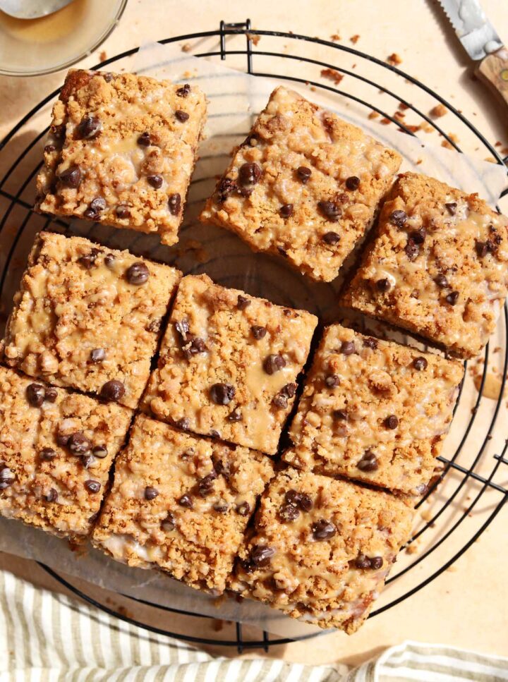 sliced chocolate chip banana bread coffee cake on cooling rack with spoon of espresso glaze
