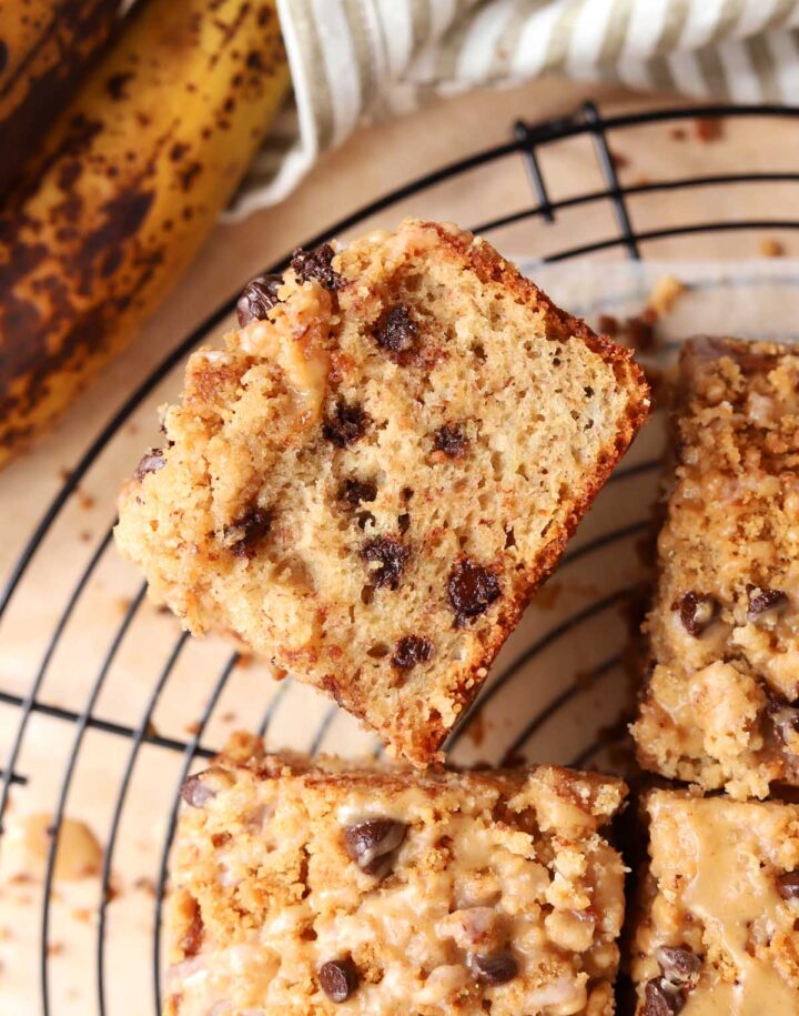 chocolate chip banana bread coffee cake on cooling rack with banana