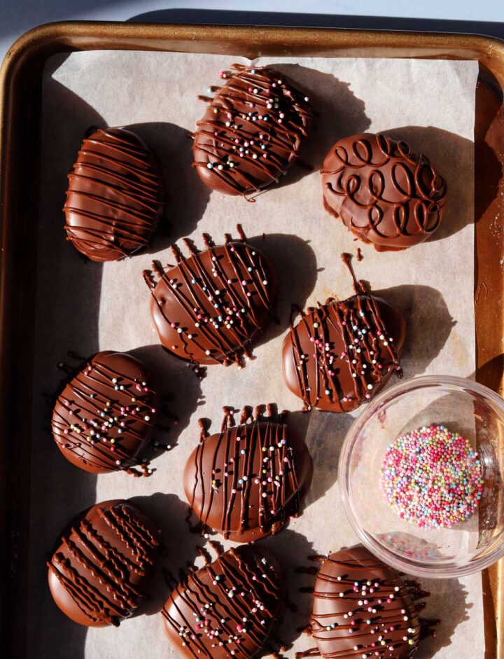 Reese's chocolate peanut butter eggs dipped in chocolate on baking sheet