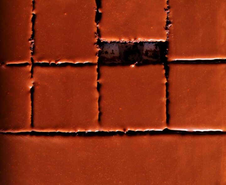 top view of chocolate sheet cake sliced in sheet pan with chocolate icing