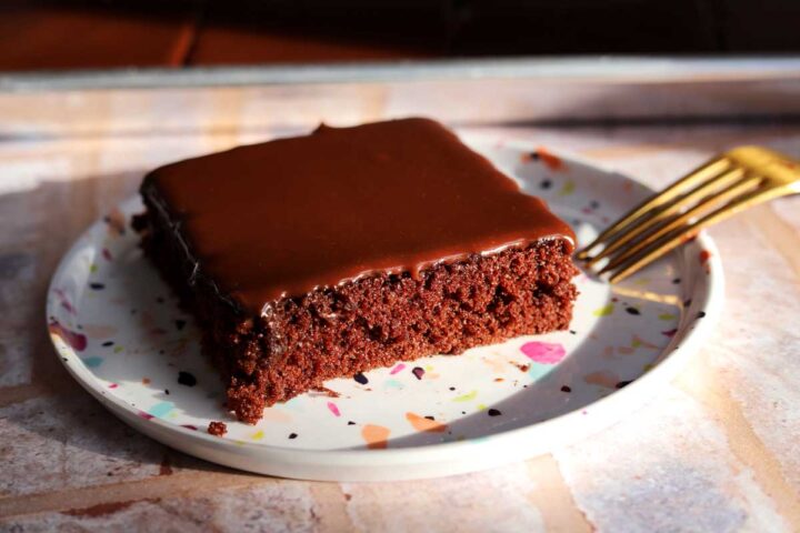 slice of chocolate Texas sheet cake on a plate with fork