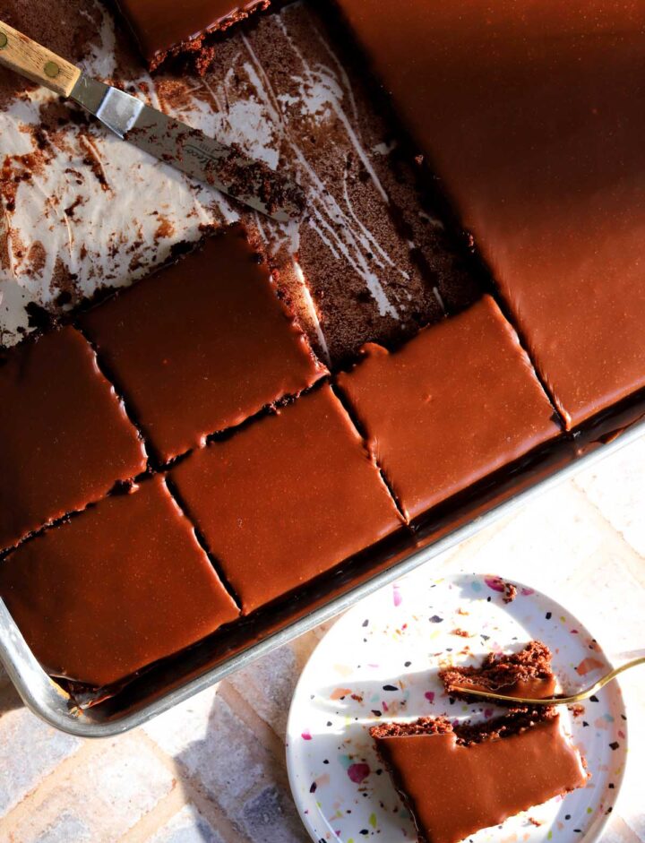 top view of chocolate sheet cake sliced in sheet pan with chocolate icing