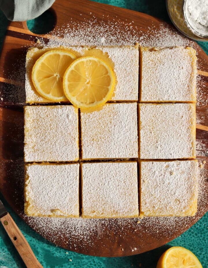 top view of creamy lemon bars sliced on cutting board