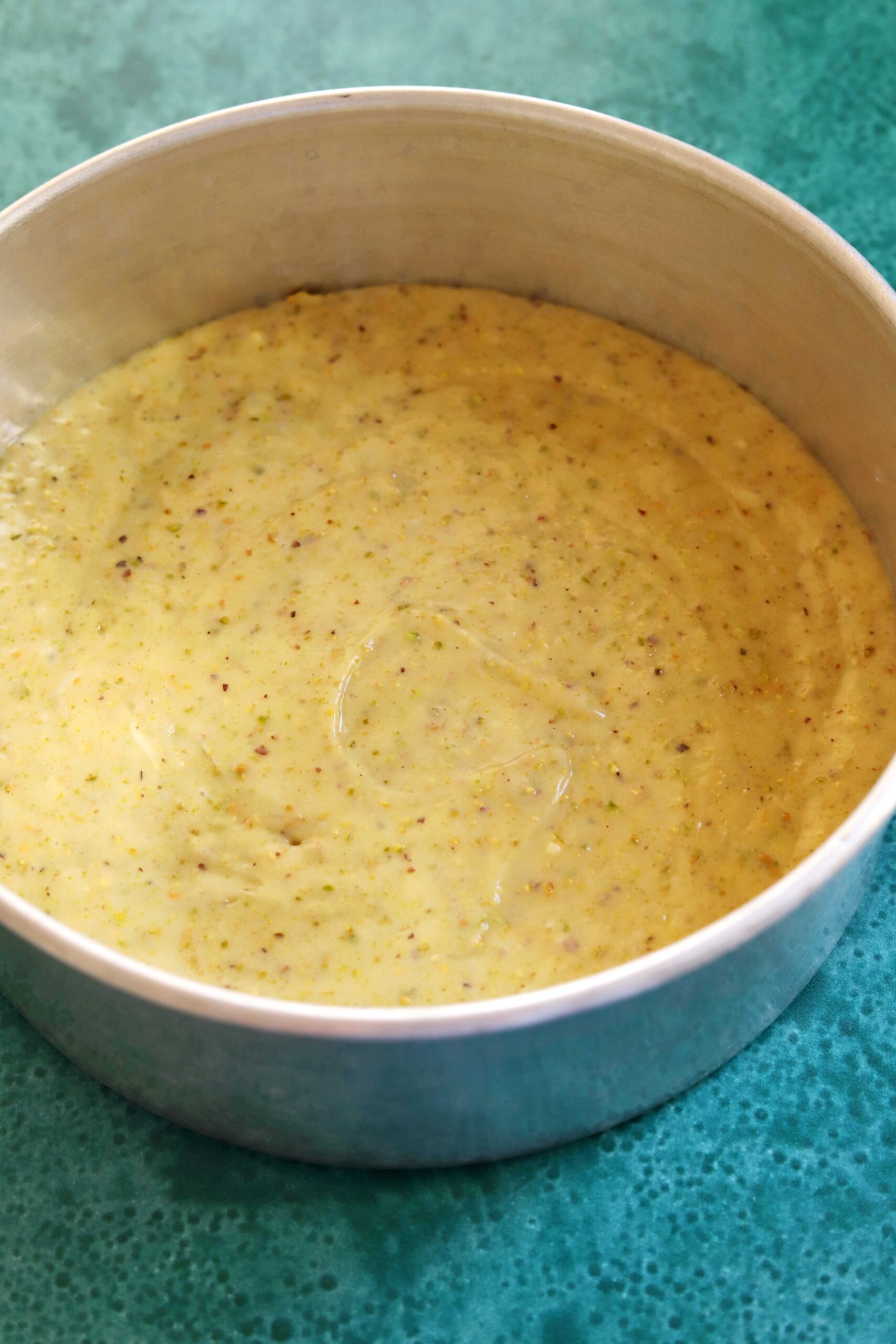 olive oil pistachio cake batter in baking pan