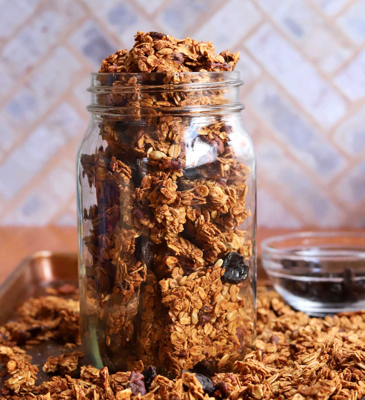 crunchy maple pecan egg white granola clusters in a glass jar