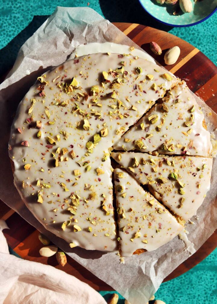 olive oil pistachio cake sliced on cutting board