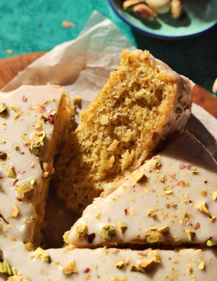 olive oil pistachio cake sliced on board