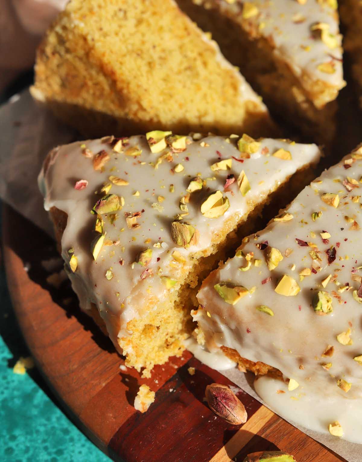 olive oil pistachio cake sliced on board