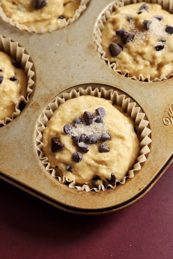healthy Greek yogurt chocolate chip muffin batter in muffin pan before baking