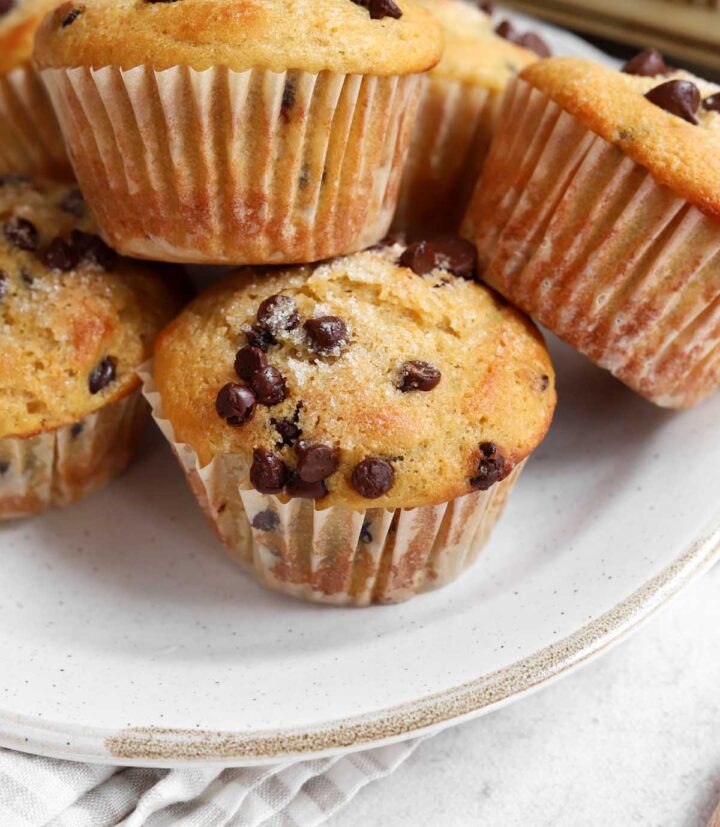 healthy Greek yogurt chocolate chip muffins stacked on a plate