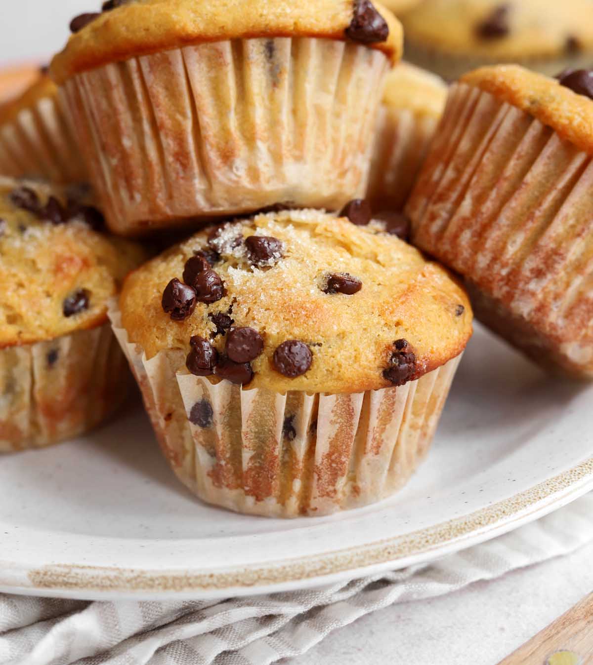 healthy Greek yogurt chocolate chip muffins stacked on a plate