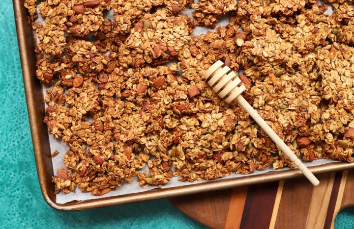 honey almond egg white granola in baking pan and broken into clusters