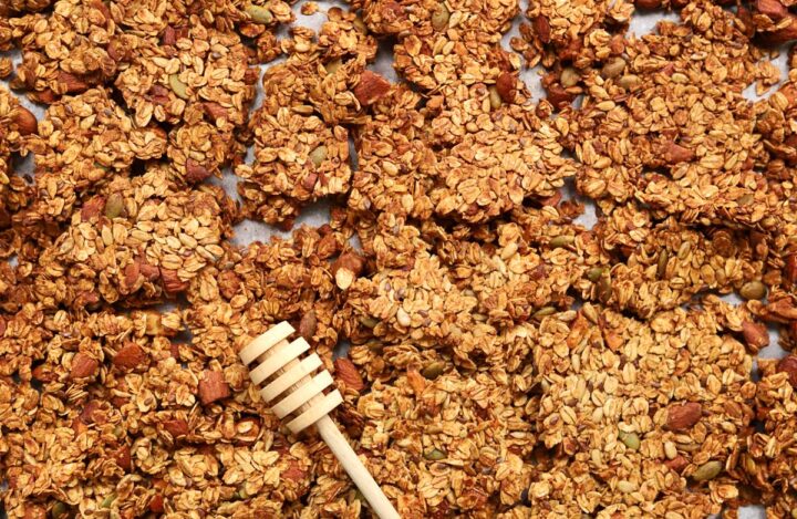 honey almond egg white granola in baking pan and broken into clusters