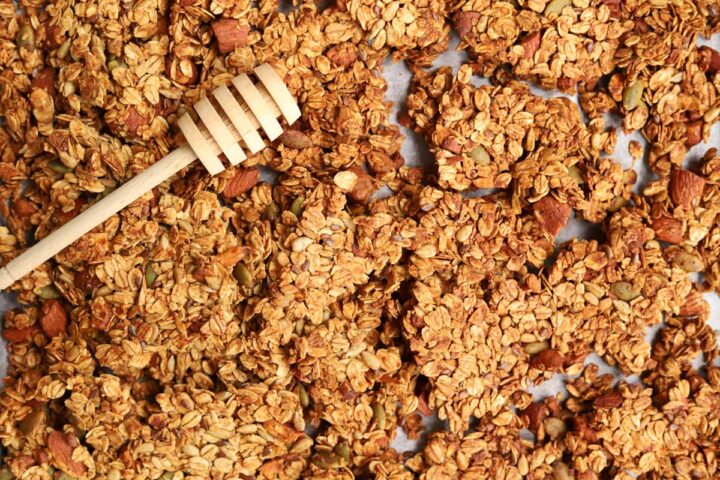 honey almond egg white granola on baking sheet