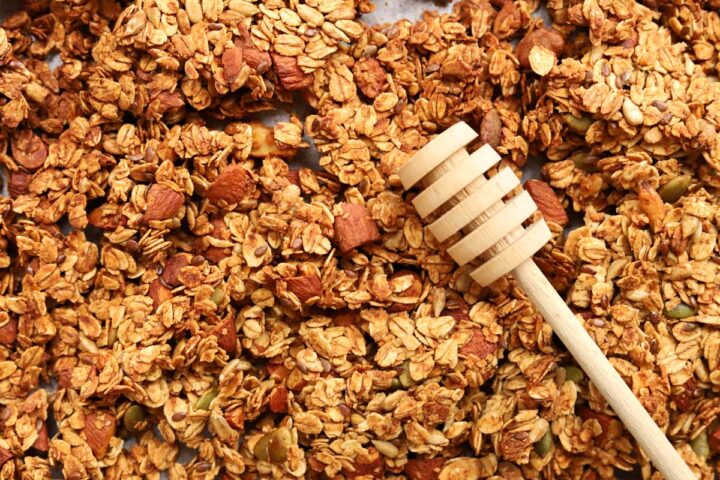honey almond egg white granola on baking sheet