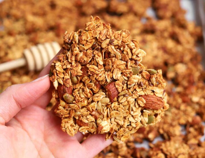 holding a big cluster of honey almond egg white granola