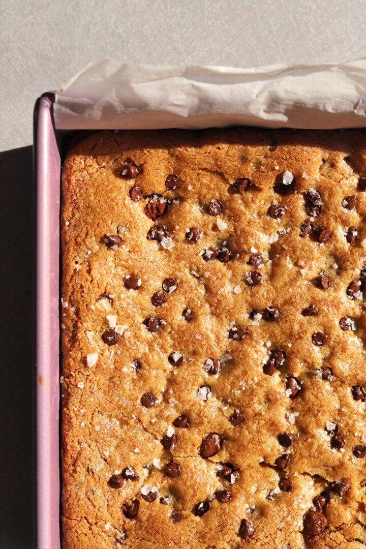 close up of chocolate chip cookie brownies in baking pan