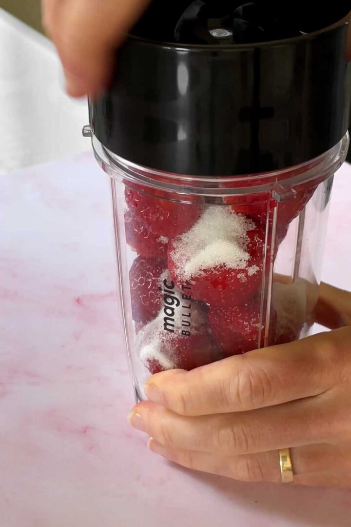Puree strawberries and sugar until smooth.