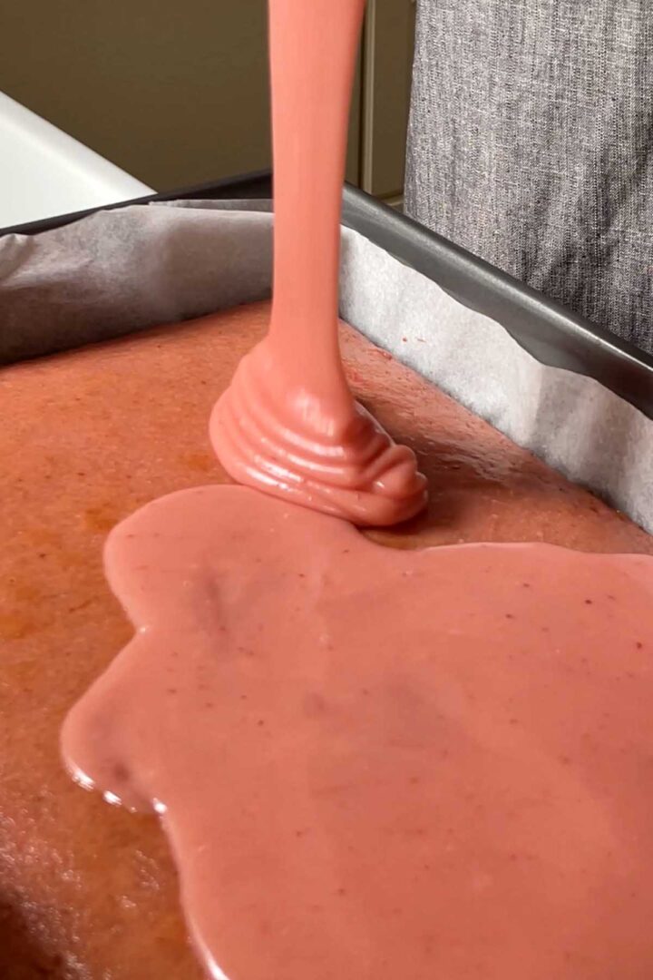 Pour icing over the cake while it is still just slightly warm.