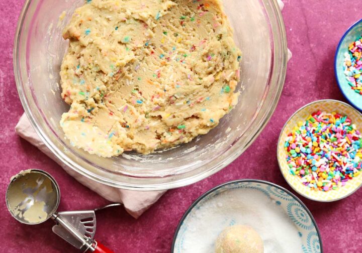 sprinkle sugar cookie dough in bowl with scoop