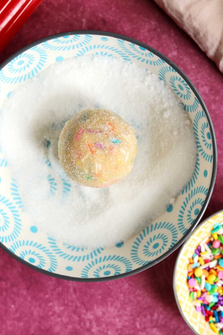 sprinkle sugar cookie dough ball rolled in sugar