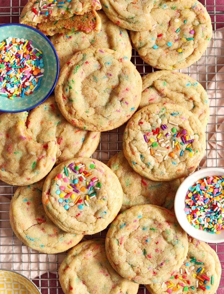 top view of soft and chewy sprinkle sugar cookies on cooling rack