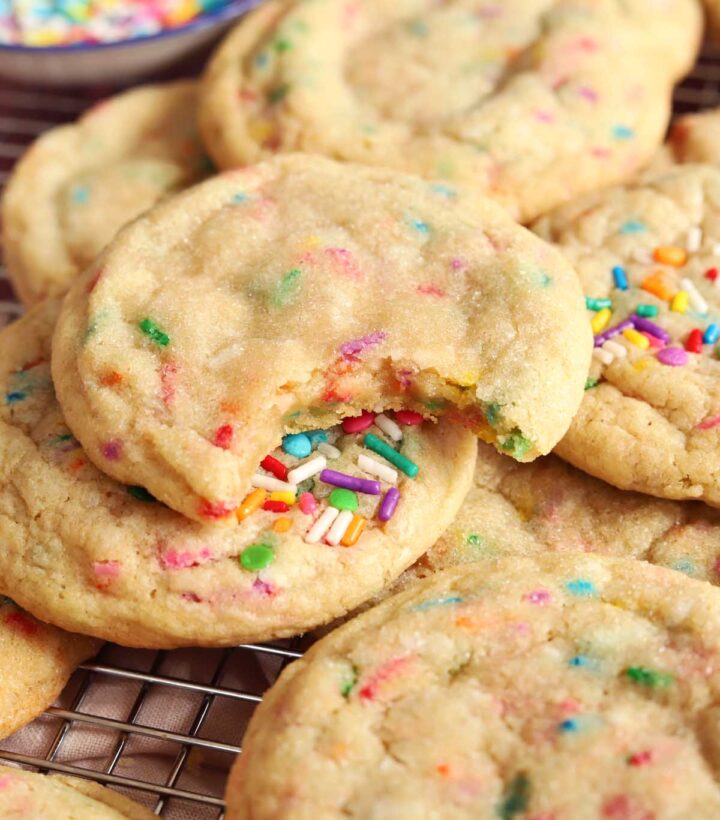 soft and chewy sprinkle sugar cookies with bite on cooling rack
