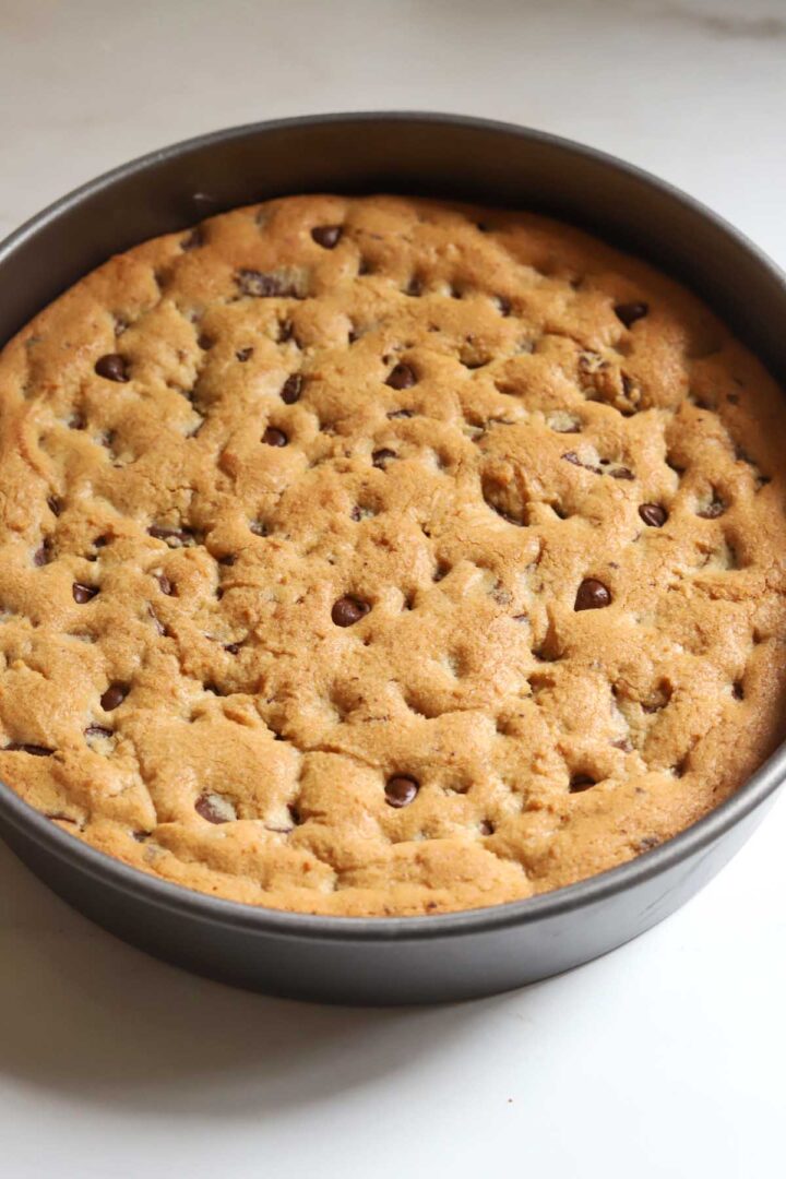 chocolate chip cookie cake in baking pan fresh from oven