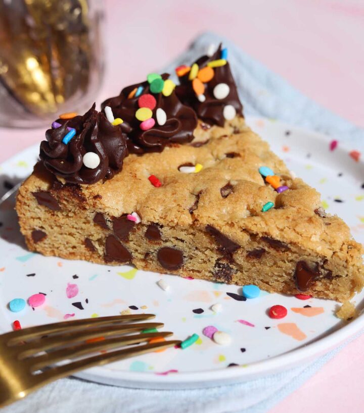 slice of chocolate chip cookie cake on a plate with fork
