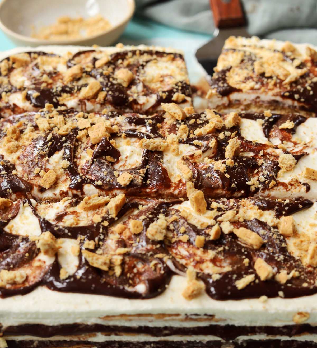 no bake s'mores icebox cake sliced on parchment paper