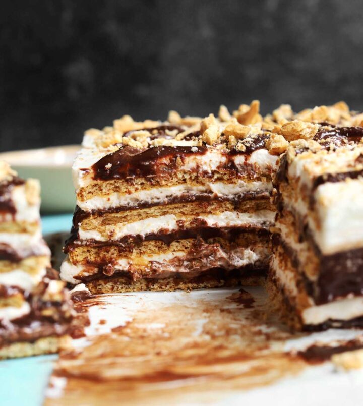 no bake s'mores icebox cake sliced on parchment paper showing cross section