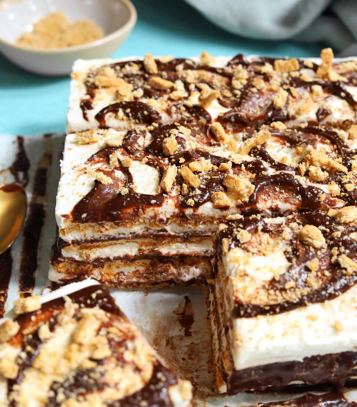 no bake s'mores icebox cake sliced on parchment paper showing cross section