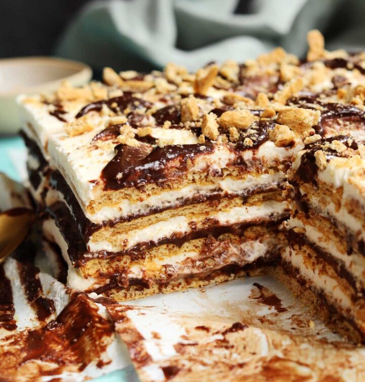 no bake s'mores icebox cake sliced on parchment paper showing cross section
