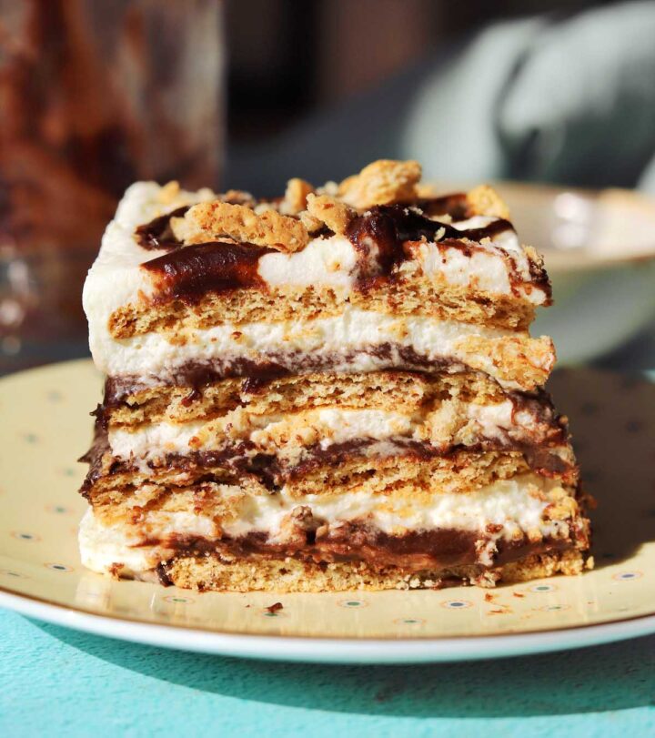 no bake s'mores icebox cake slice on a plate with bite